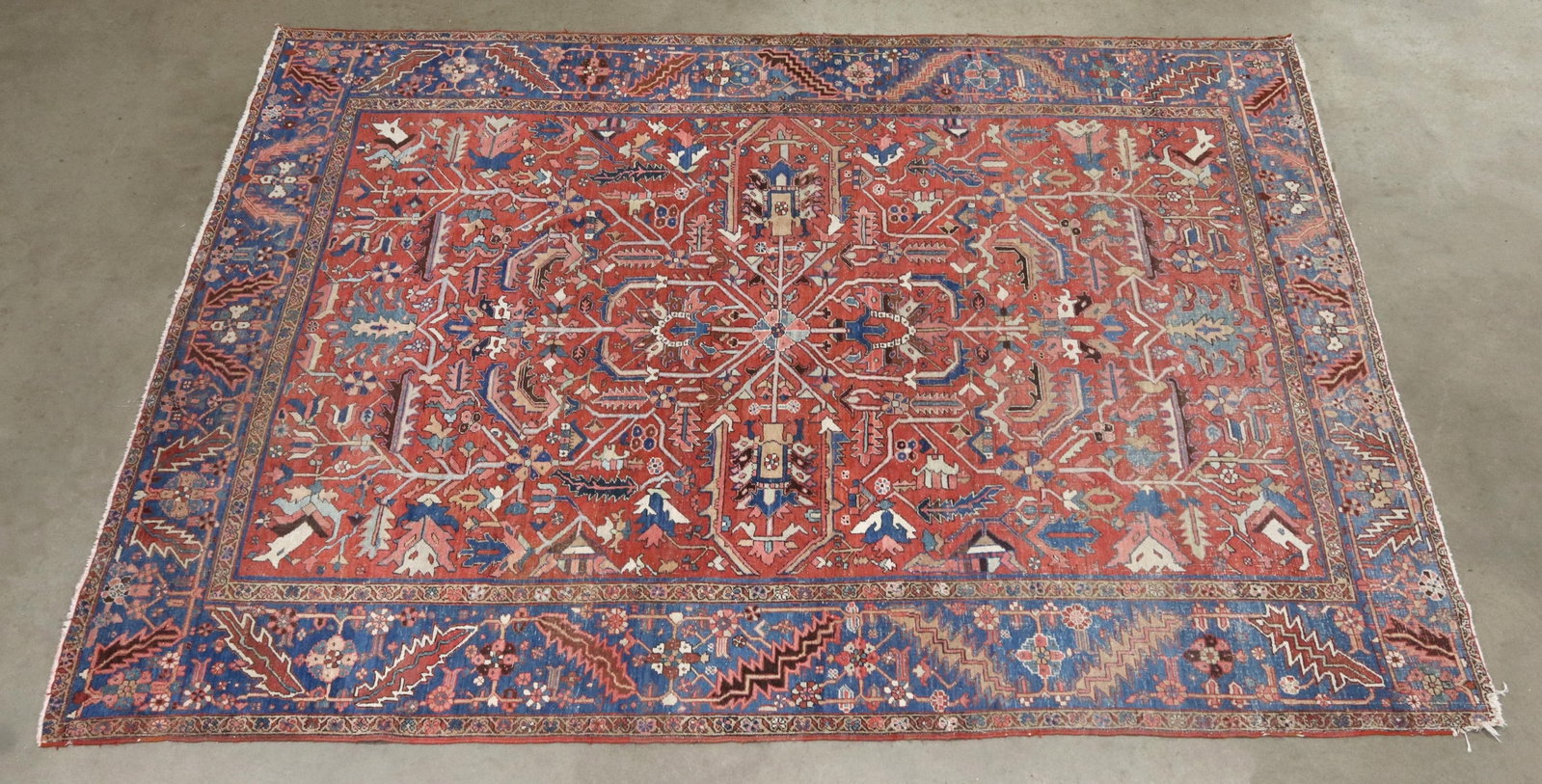 HAND-TIED PERSIAN MEHRIVAN HERIZ RUG, 12'2" X 9'4": Hand-tied Persian Mehrivan Heriz rug, some overall pile loss with areas of exposed warp, loss and fraying to one corner, approx 12'2"l, 9'4"w **Provenance: From a fine Houston, Texas estate** **Please
