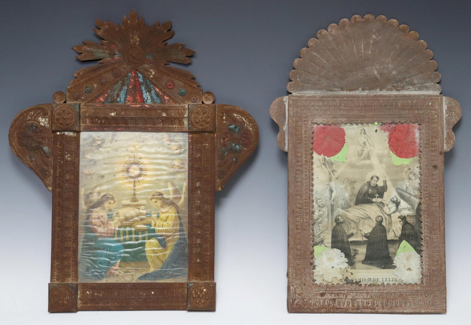 (2) FRAMED RETABLO PRINTS, RELIGIOUS FIGURES: (lot of 2) Framed retablo prints, Mexico, each housed in an embossed metal nicho/ frame, including: (1) Camillus de Lellis, remnants of polychrome paint, retaining paper flowers, (1) depicting two ang