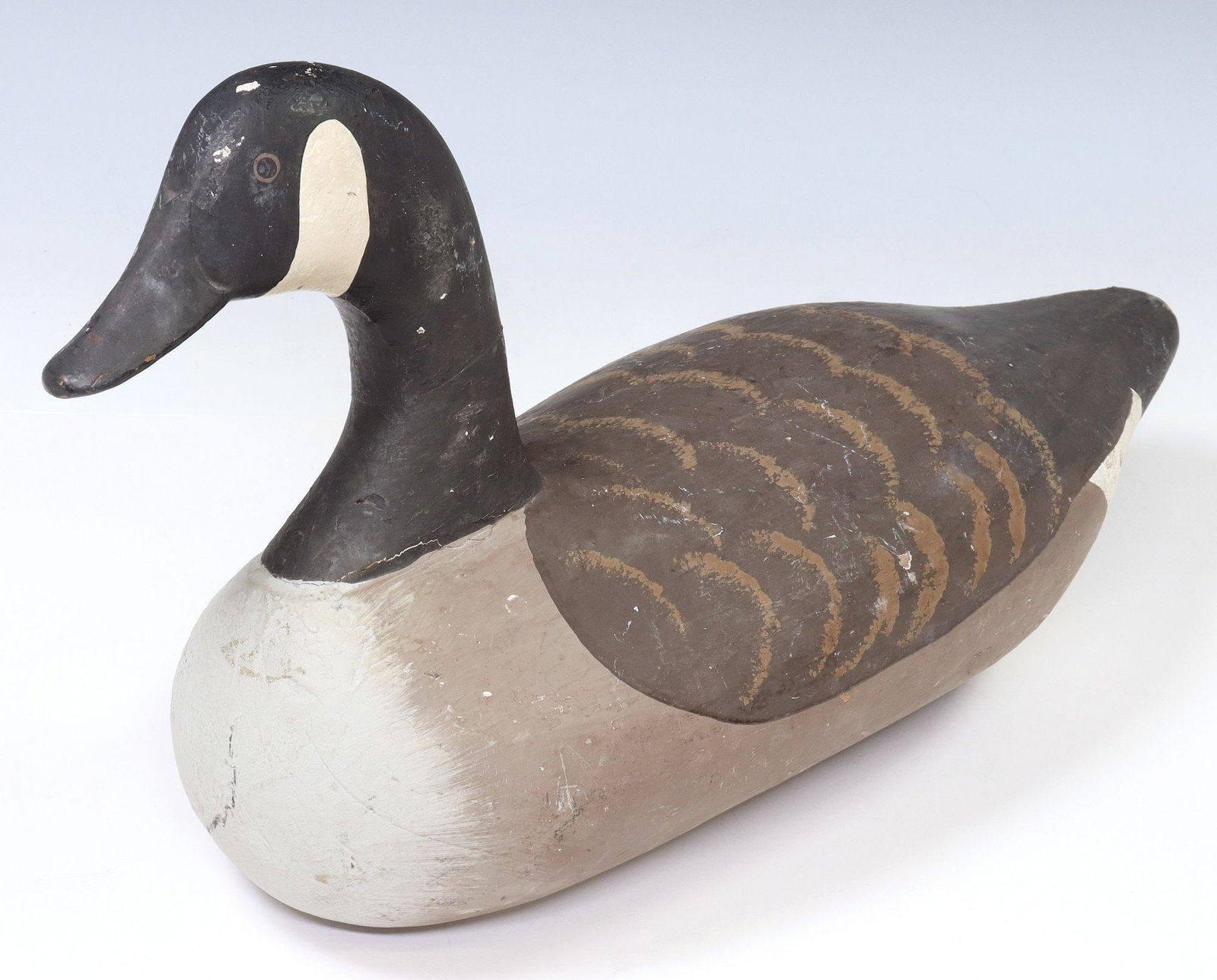 CARVED & PAINTED WEIGHTED CANADA GOOSE DECOY: Weighted Canada goose decoy, inscribed "Rusty" underfoot, with small chip to top of head, approx 11"h, 19.5"w, 8"d, 8.25lbs 