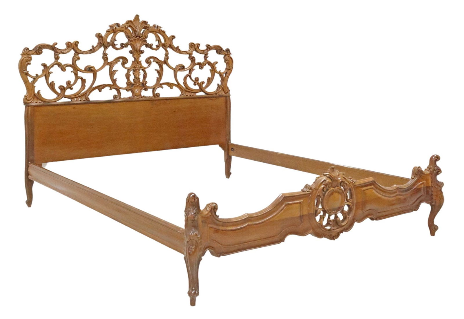 ITALIAN ROCOCO STYLE CARVED WALNUT BED: Italian Rococo style carved walnut bed, 20th c., pierced headboard with scrolled foliates and shell motifs, paneled footboard with central carved scrollwork, joined by straight rails, rising on cabrio
