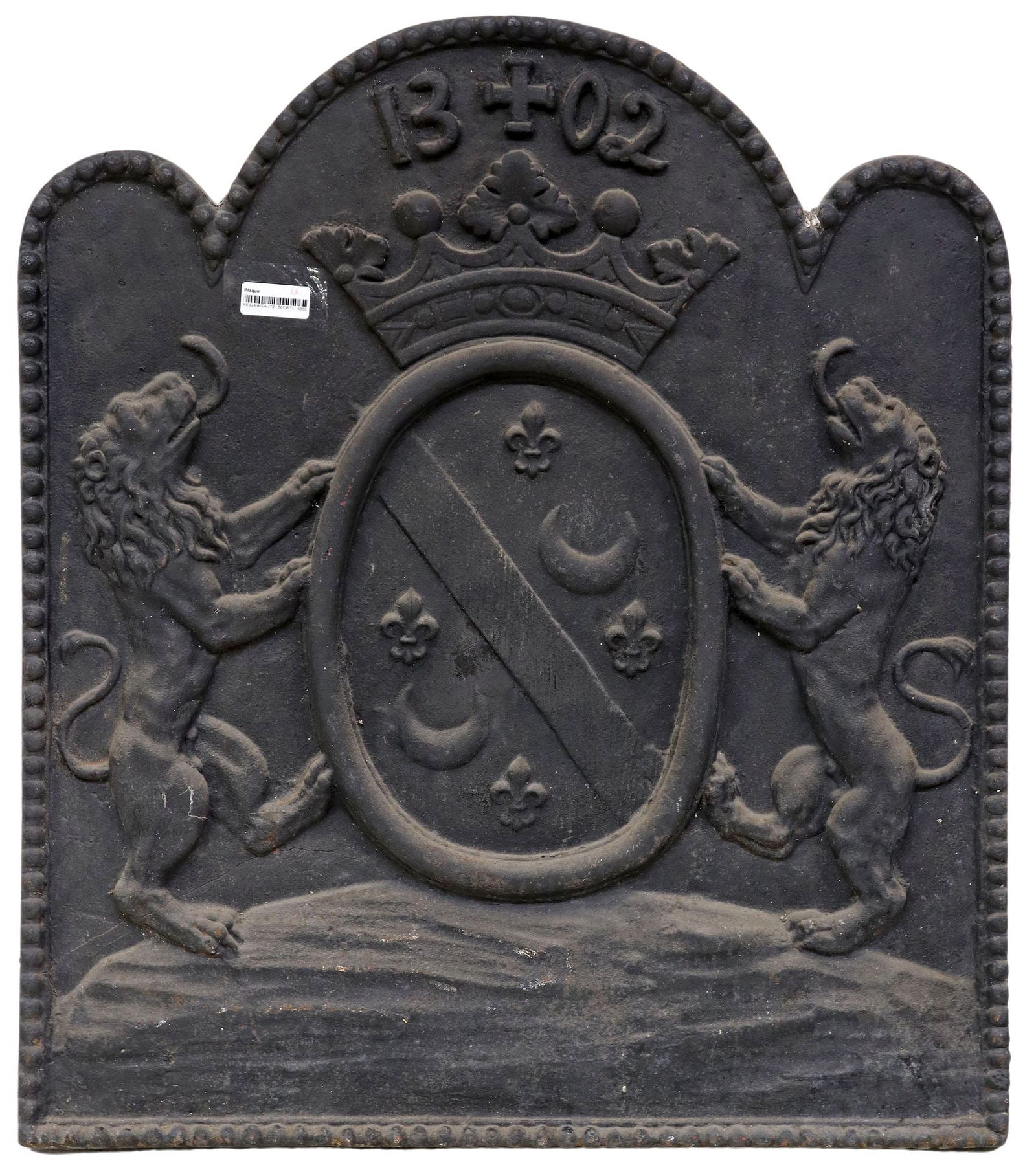 FRENCH CAST IRON ARMORIAL FIREBACK PANEL: French cast iron fireback panel, of shaped form, with coat of arms containing lions, fleur-de-lis, and crescent moons dating "1302" in relief, approx 35 7/8"h, 31"w