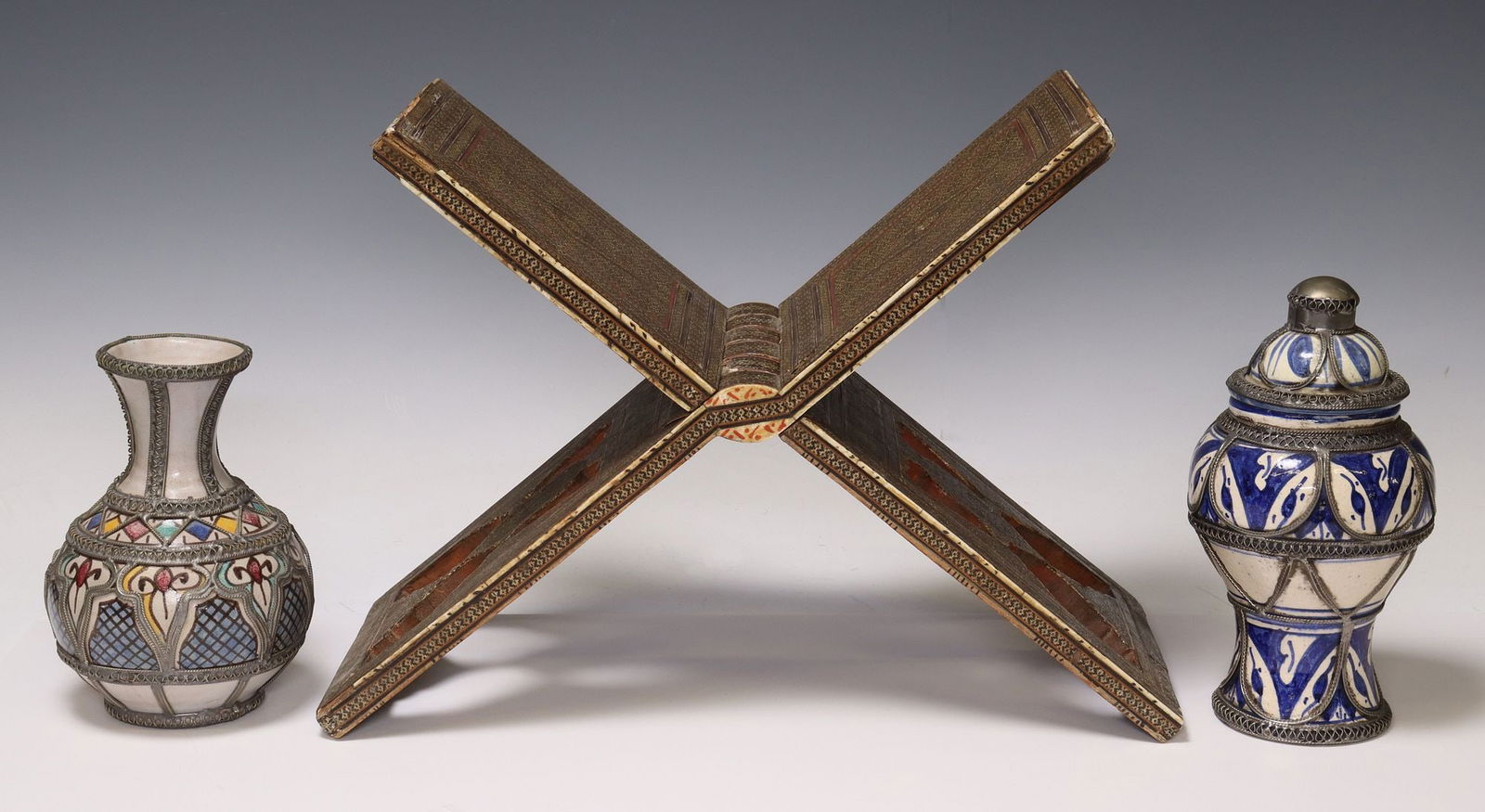 (3) PERSIAN KHATAM QURAN STAND & MOROCCAN METAL-MOUNTED POTTERY: (lot of 3) Decorative objects, including: (1) Persian Khatam folding Quran holder, small losses to mosaic inlay, open: approx 11"h, 15.5"l, 6.75"w, (2) Moroccan metal-mounted earth