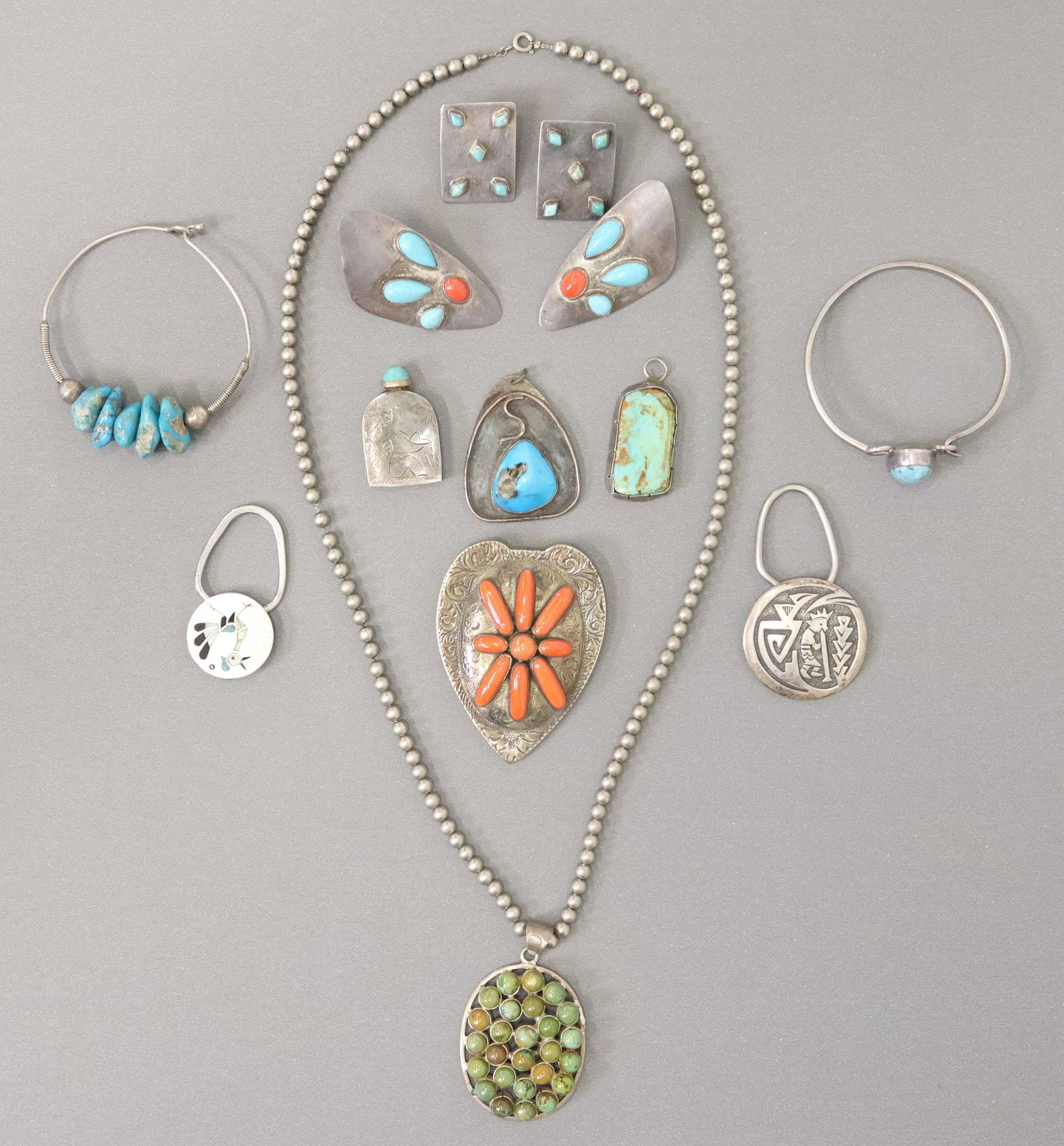 (11) SOUTHWEST SILVER & OTHER METAL TURQUOISE JEWELRY: (lot of 11) Southwest sterling silver and other metal jewelry, including: keyrings, bangles, earrings, pendants, miniature perfume/ scent flask, etc.; 180 grams total (inclusive of all materials)