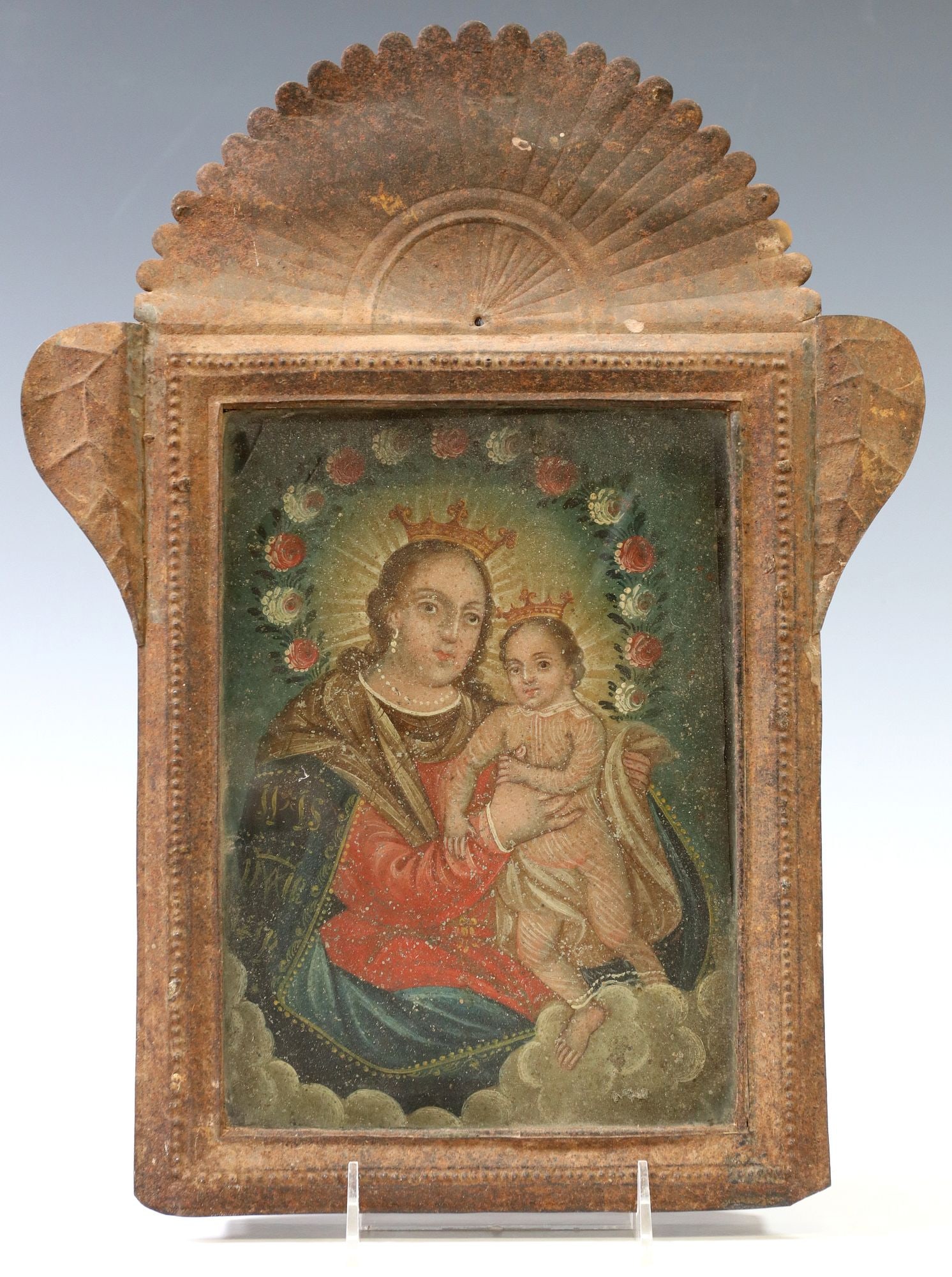 FRAMED OIL ON TIN RETABLO, NUESTRA SENORA DEL RUFUGIO: Framed oil on tin retablo, Nuestra Senora del Refugio (Our Lady of Refuge), depicting the Virgin Mary and Christ Child enthroned above clouds, in pressed metal frame behind glass, overall: approx
