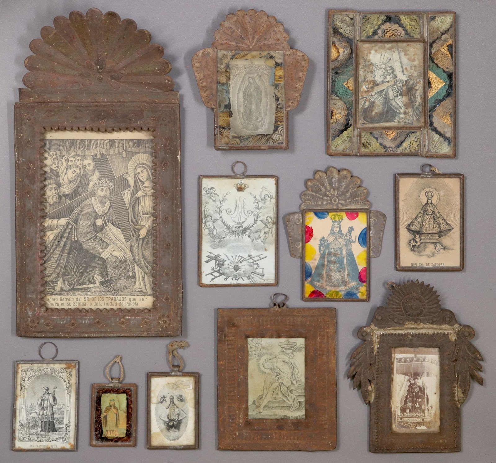 (11) FRAMED RELIGIOUS RETABLO PRINTS, MEXICO: (11) Framed retablo prints, Mexico, each housed in an embossed metal nicho/ frame, highlights include: (1) Nuestra Senora de Zapopan, with Spanish prayer verso; (1) La Virgen de Guadalupe, painted bor