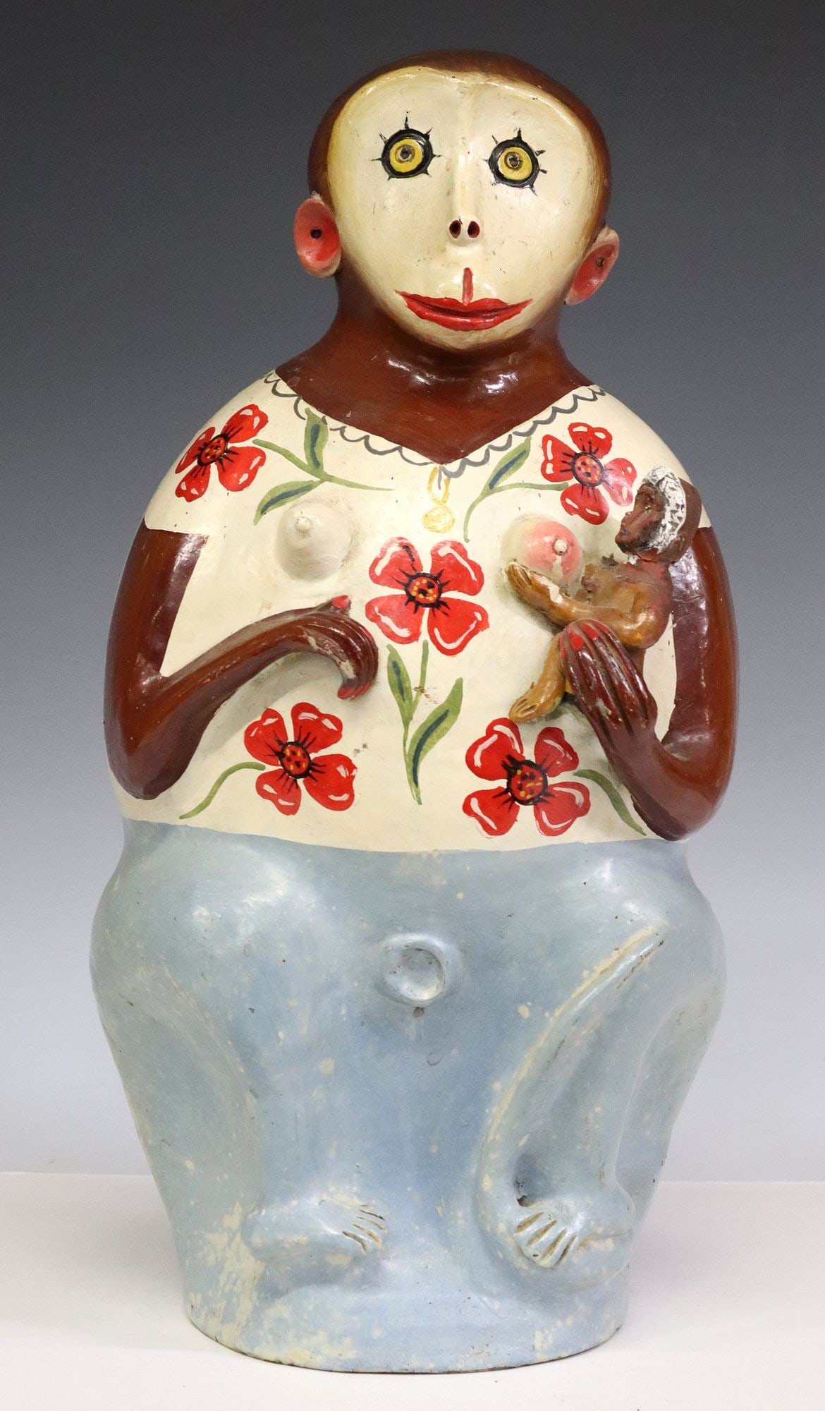 FOLK ART POTTERY CHANGO MONKEY JAR, MEXICO: Folk art pottery Chango bottle, Oaxaca, Mexico, modeled as a monkey holding child at chest, with polychrome painted features, hole at lower back and top of head, possible restoration to child's he