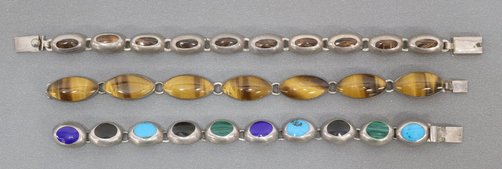 (3) STERLING SILVER & STONE LINK BRACELETS, MEXICO: (lot of 3) Sterling silver and stone link bracelets, Mexico, including: (2) tiger's eye, (1) multi-stone; smallest: approx 6.75"l, largest: approx 7.75"l, 80 grams total (inclusive