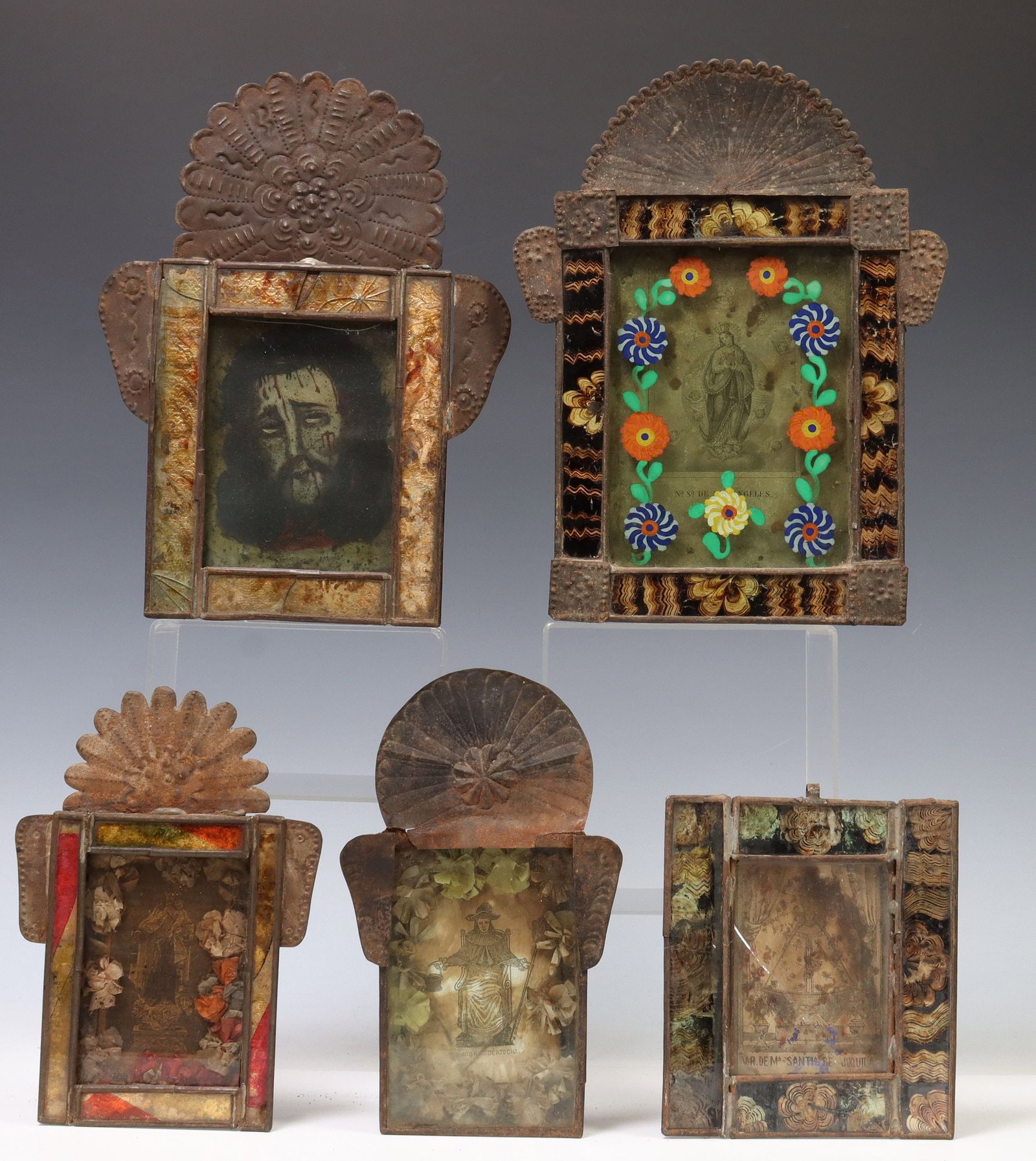 (5) FRAMED RELIGIOUS RETABLO PRINTS, MEXICO: (lot of 5) Framed retablo prints, Mexico, each housed in an embossed metal nicho/ frame, four with glass borders, including: (1) Santo Nino de Atocha, with paper flowers; (1) Jesus Christ, loose front