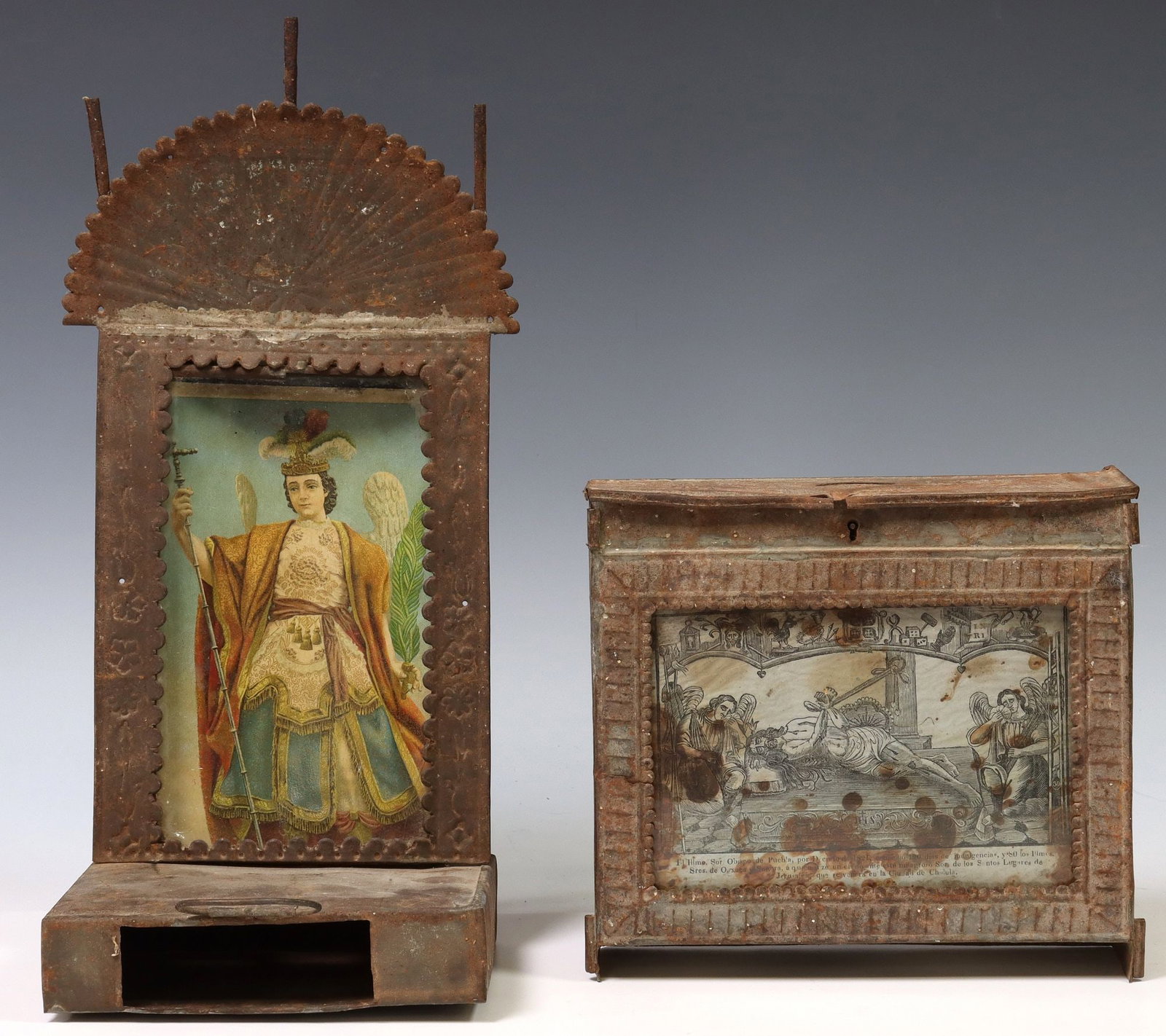 (2) FRAMED TIN ALMS BOXES WITH RELIGIOUS FIGURES, MEXICO: (lot of 2) Framed alms boxes with religious prints, Mexico, both with handles to back, including: (1) Senor San Miguel del Milagro, having three columns protruding from metal crown, rising o