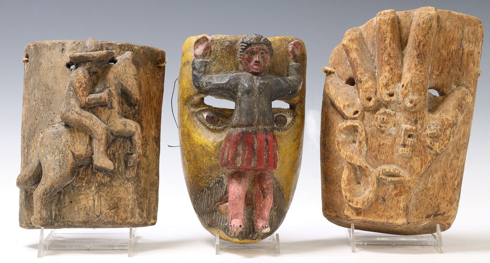 (3) MEXICO FOLK ART CARVED WOOD FIGURAL DANCE MASKS: (lot of 3) Mexico folk art carved wood dance masks, including: (1) polychrome painted with figure on face, possibly Guerrero, (1) hand with symbols in relief, (1) figural man with horse in relief, lar