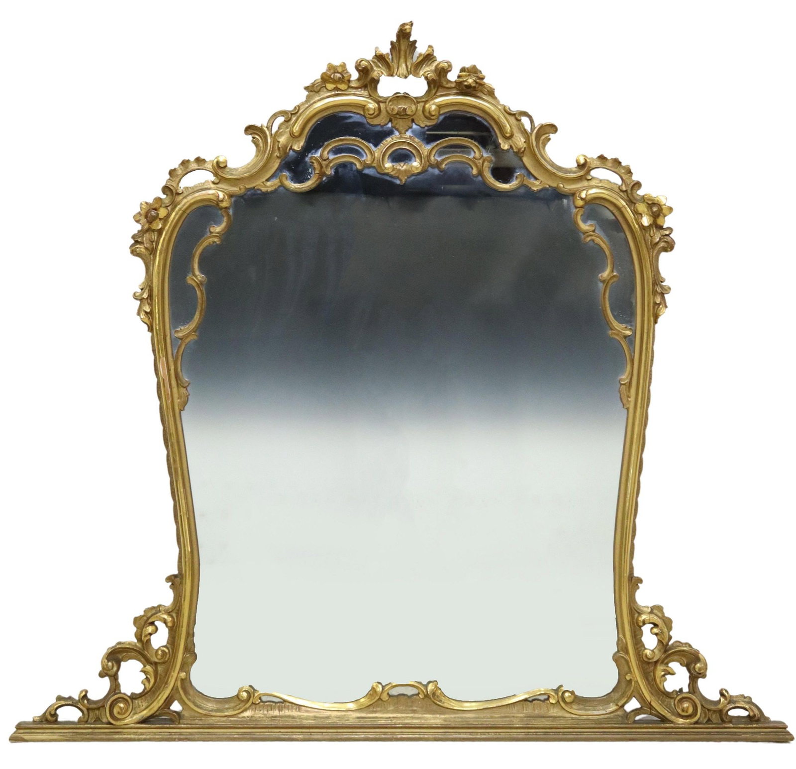 LOUIS XV STYLE GILTWOOD OVERMANTEL MIRROR: Louis XV style giltwood overmantel mirror, early 20th c., fanned crest, over scrolled cushion frame, with raised floral and foliate motifs, encasing flat mirror plate, approx 47"h, 50.5"w, 3