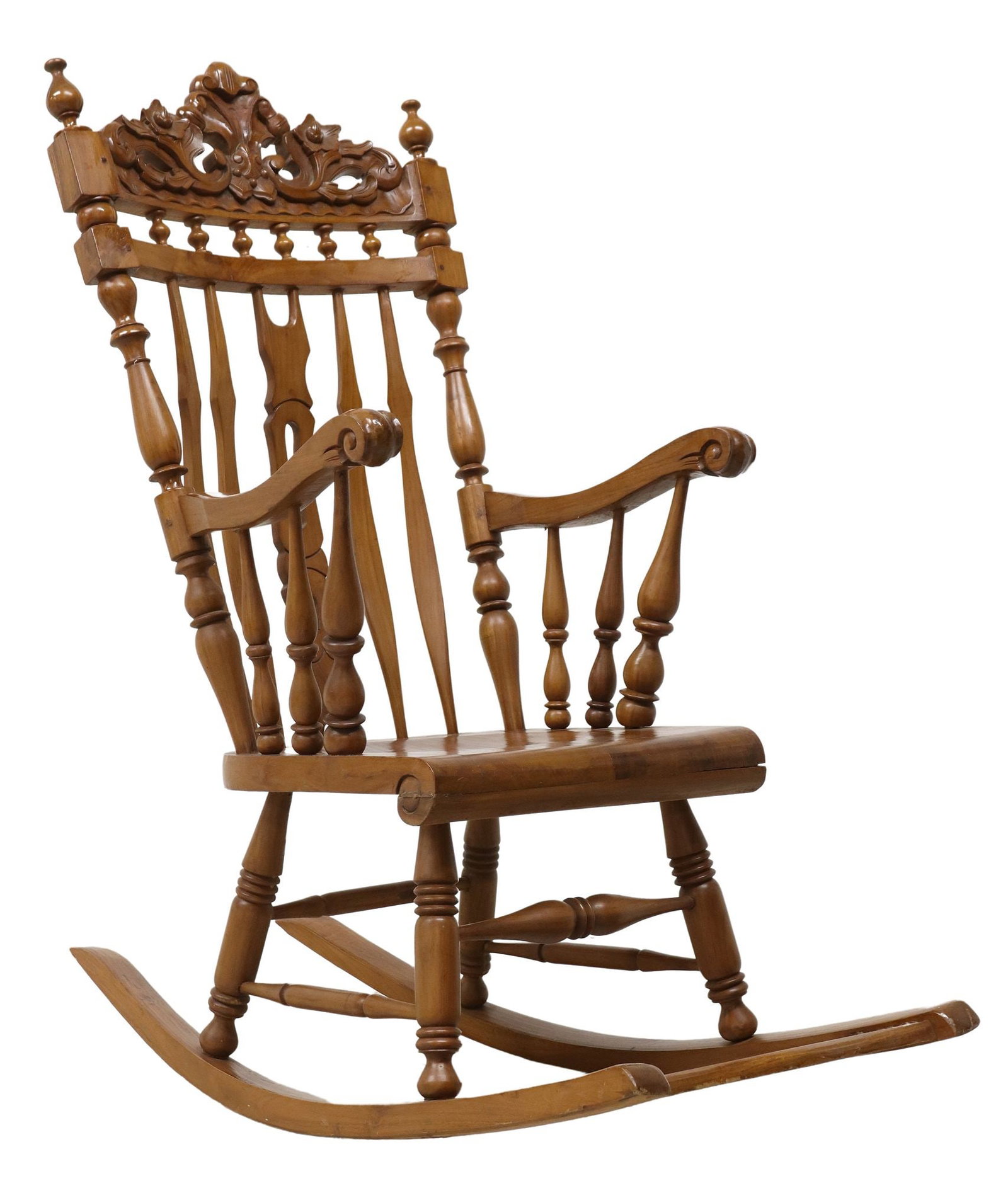 CARVED WINDSOR STYLE ROCKING CHAIR: Windsor style rocking chair, 20th c., having top carved crest with turned finials, over spindle gallery, slatted back, scrolled arms on turned supports, contoured seat, stretcher-joined turned le