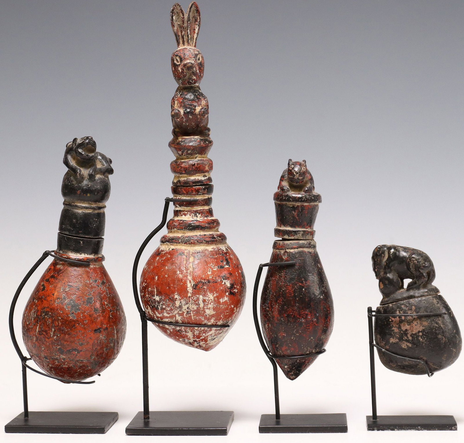 (4) CARVED & PAINTED SEED POD BOXES ON DISPLAY STANDS: (lot of 4) Carved and polychrome painted seed pod boxes, possibly Southeast Asia, varied designs, each having lid modeled as an animal, accompanied by metal display stand, largest: approx 11.75"h