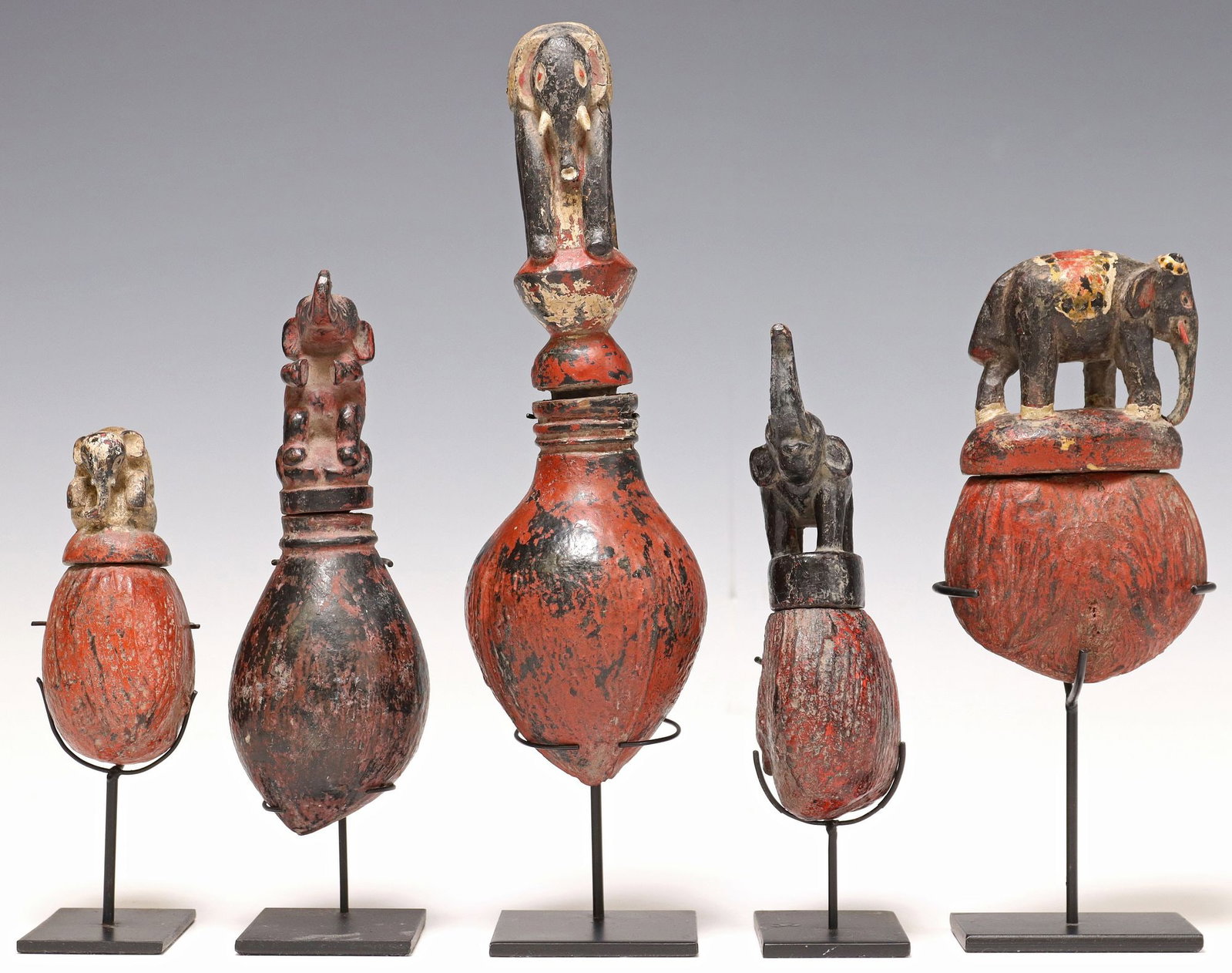 (5) CARVED & PAINTED SEED POD BOXES ON DISPLAY STANDS: (lot of 5) Carved and polychrome painted seed pod boxes, possibly Southeast Asia, varied designs, each having lid modeled as an elephant, accompanied by metal display stand, largest: approx 12.75"
