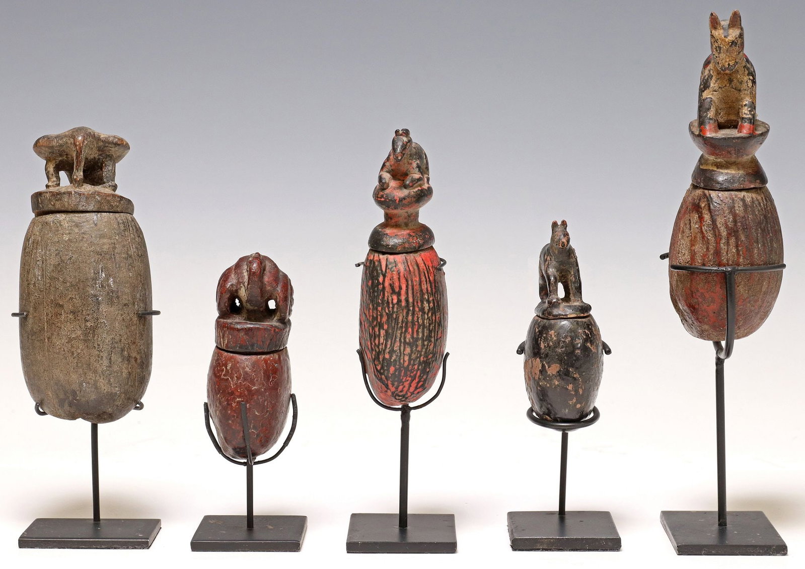 (5) CARVED & PAINTED SEED POD BOXES ON DISPLAY STANDS: (lot of 5) Carved and polychrome painted seed pod boxes, possibly Southeast Asia, varied designs, each having lid modeled as an animal, accompanied by metal display stand, largest: approx 9.75"h,
