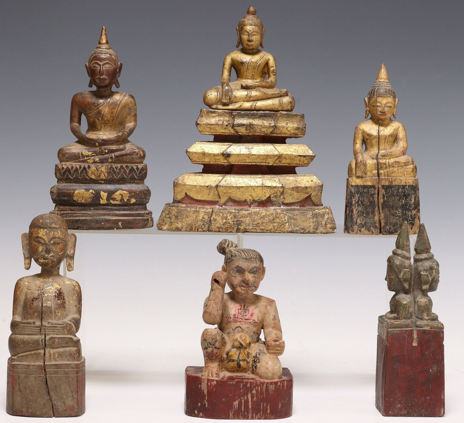 (6) SOUTHEAST ASIAN CARVED & PAINTED BUDDHA FIGURES: (lot of 6) Southeast Asian carved wood figures, varied designs, most depicting the seated Buddha, with remnants of gilt and polychrome paint, rising on integral platform base, largest: approx 8"h