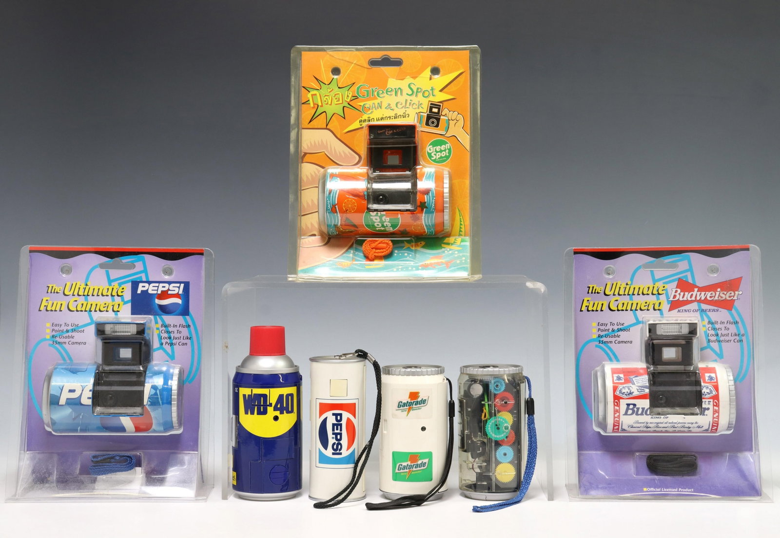 (7) NOVELTY CAMERA "CANS" BUD GATORADE, WD40 PEPS: (lot of 7) Novelty cameras in cans: (1) Budweiser in original packaging, unopened; (1) Green Spot; (1) Gatorade; (1) Pepsi in original packaging, unopened; (1) WD-40; (1) clear acrylic "can" showing c