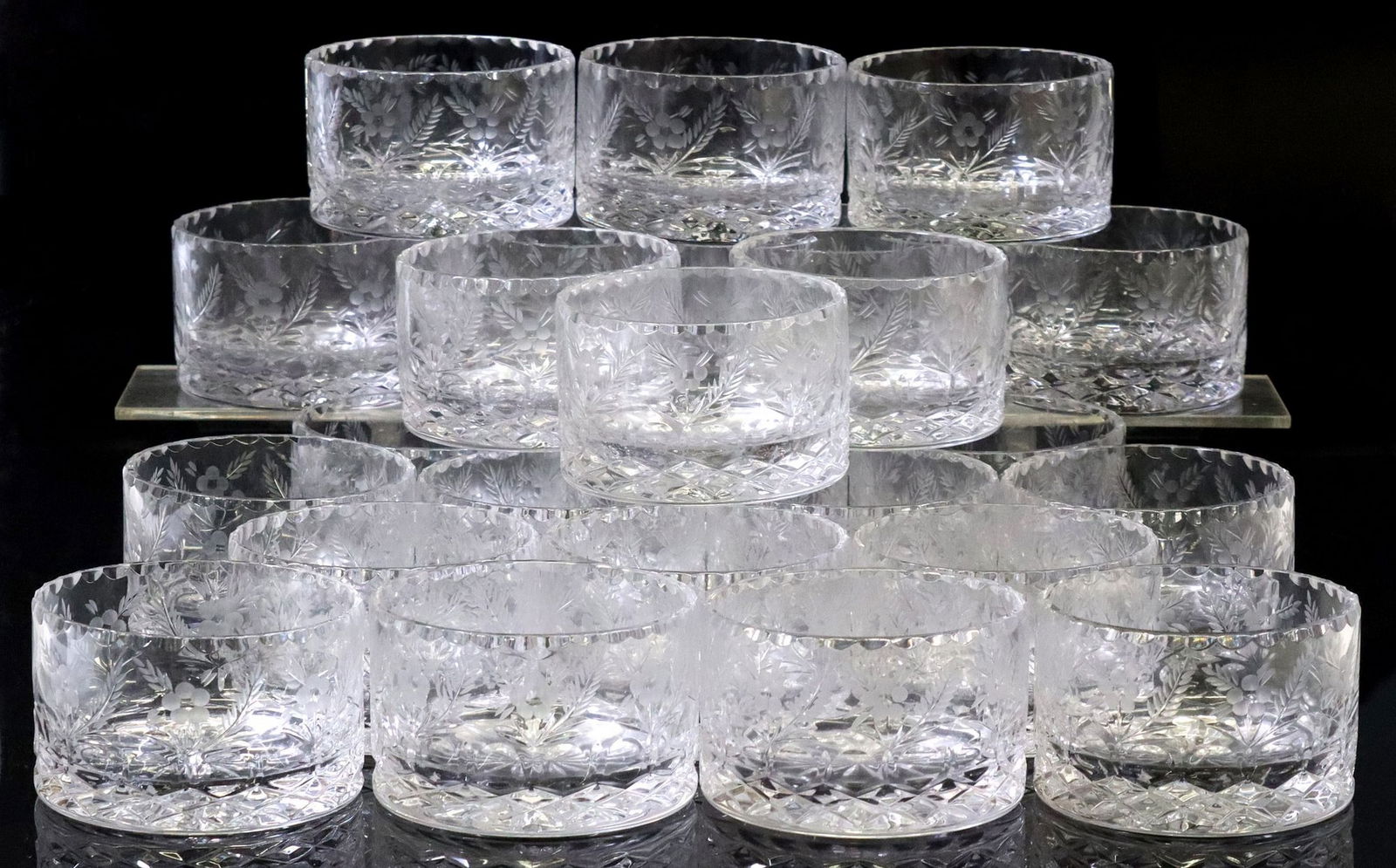 (23) CRYSTAL CLEAR INDUSTRIES 'CELINE' WINE BOTTLE COASTERS: (lot of 23) Crystal Clear Industries cut crystal wine bottle coasters, in the "Celine" pattern, floral trim over vertical cuts and crisscross pattern, approx 2 5/8"h, 4 1/8&qu