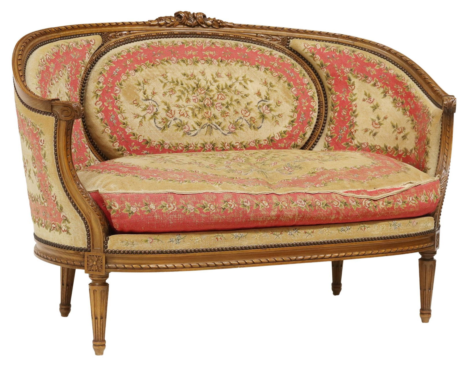 FRENCH LOUIS XVI STYLE NEEDLEWORK UPHOLSTERED SALON SETTEE: French Louis XVI style carved wood salon settee/ sofa, early 20th c., having floral crest and ribbon twist molding, in worn floral needlework upholstery, with nailhead trim, removable seat cushio