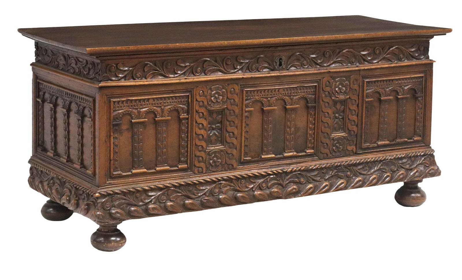 FRENCH RENAISSANCE REVIVAL COFFER/ STORAGE TRUNK: French Renaissance Revival coffer/ storage trunk, 19th c., having hinged top, over carved foliate scrolls, running ornamentation with archways, ending on bun feet, approx 25 1/8"h, 55.25"w, 