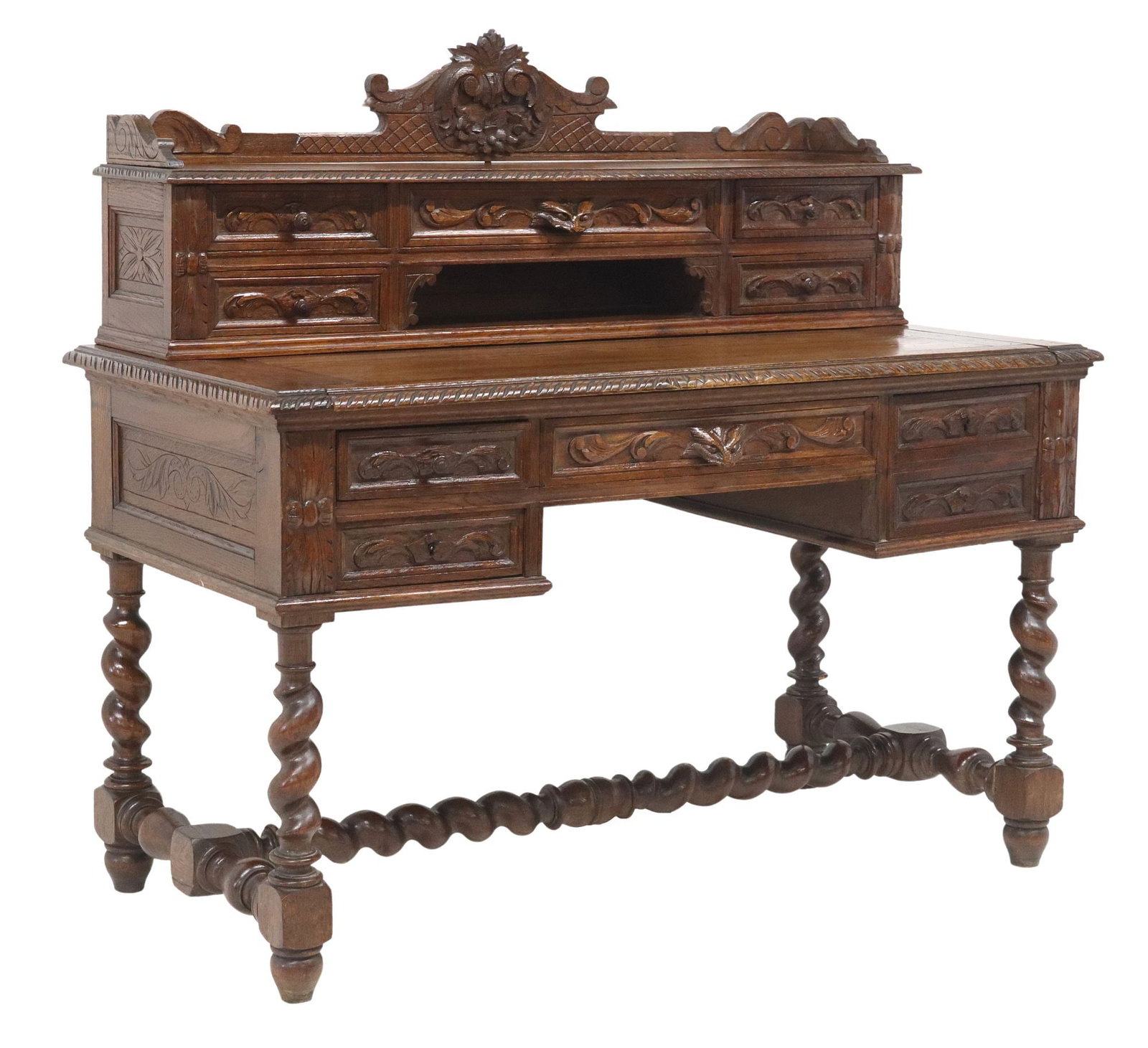 FRENCH LOUIS XIII STYLE CARVED OAK WRITING DESK: French Louis XIII style oak writing desk, late 19th c., superstructure with five drawers, above the pull-out writing surface, four drawers framing the center kneehole, on spiral turned legs joine