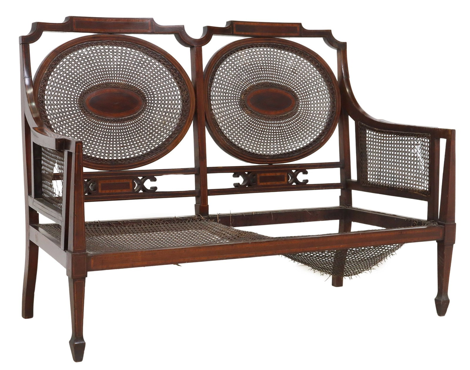 ENGLISH REGENCY SATINWOOD-BANDED MAHOGANY DOUBLE CHAIRBACK SETTEE: English Regency double chairback settee, early 19th c., mahogany frame with satinwood banding, oval medallion backs, arms, and seat with torn and missing cane, front tapering square legs, on spad