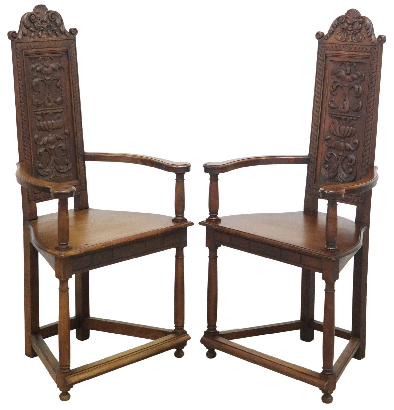 (2) RENAISSANCE REVIVAL CARVED WALNUT ARMCHAIRS: (pair) Renaissance Revival style carved walnut armchairs, early 20th c., having grotesque crest, over seat back with carved foliated and scrolling urn, with gently curved arms, rising on stretcher-joi