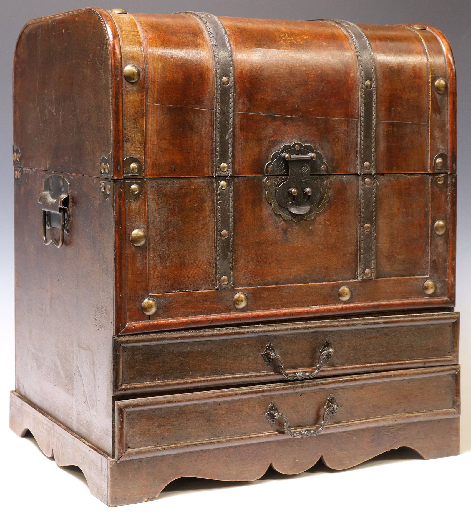 LEATHER & METAL CLAD FLATWARE STORAGE CHEST: Flatware storage chest, late 20th c., rounded hinged top opening to flatware racks, exterior with leather strapping, over two drawers, one of them compartmentalized, metal handles to either side panel