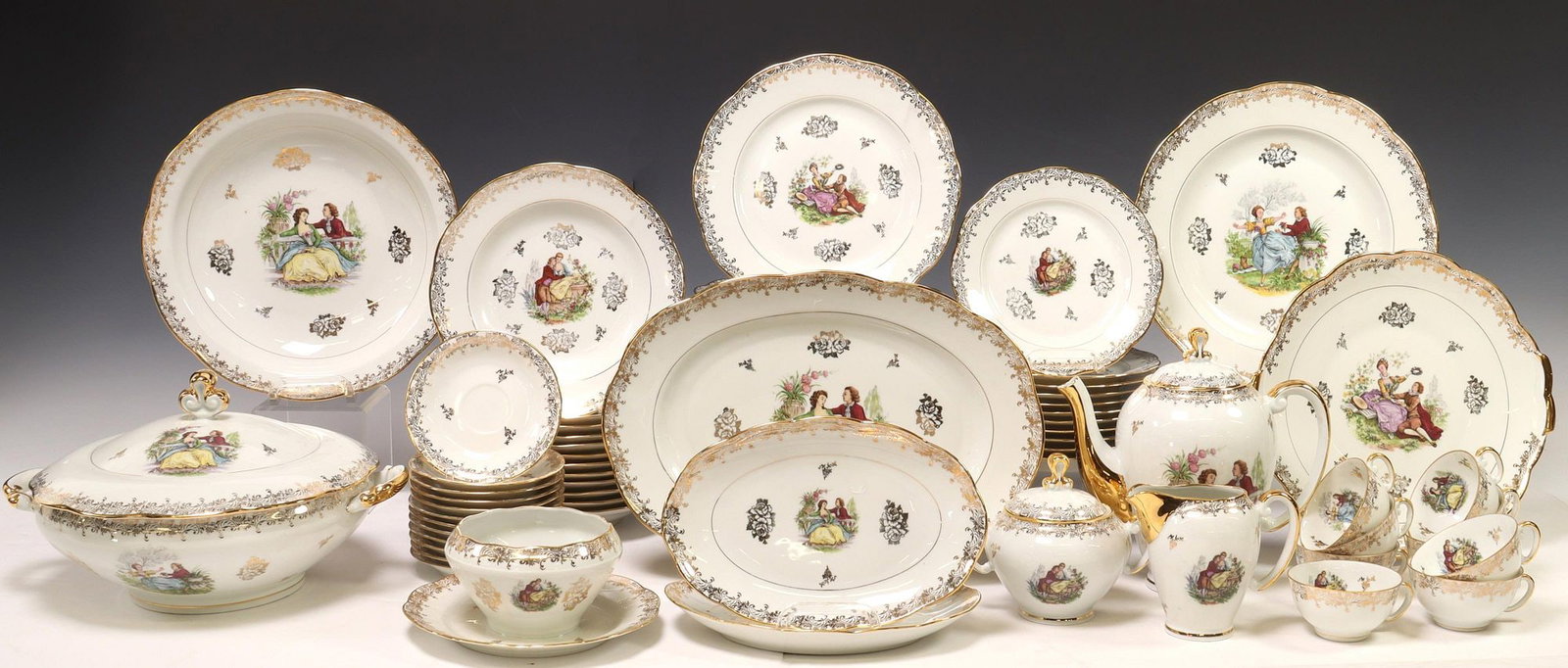 (79) FRENCH LIMOGES JV PORCELAIN DINNER SERVICE: (lot of 79) French Limoges porcelain partial dinner service, J.V. Authentique, having transferred courting couple motifs after Jean-Antoine Watteau (French, 1684-1721), parcel gilt trim, maker's m