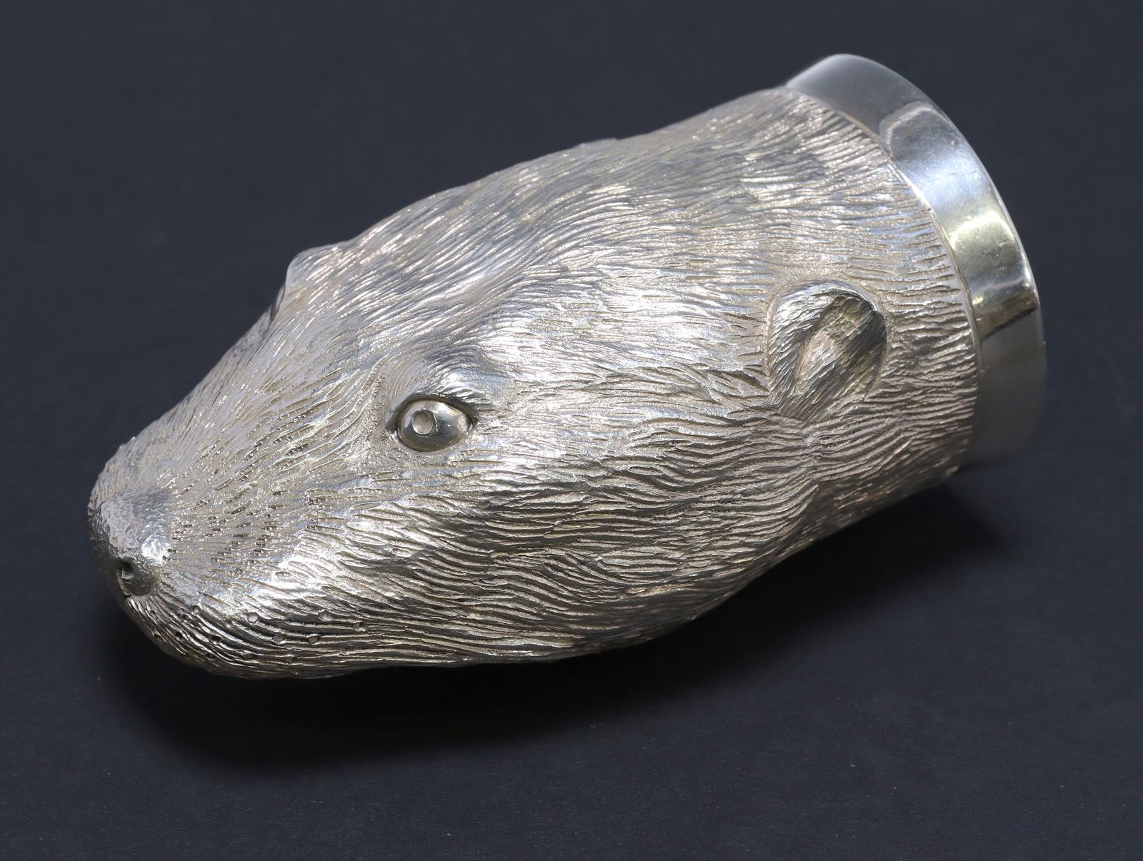 ENGLISH ELIZABETH II STERLING SILVER OTTER NOVELTY STIRRUP CUP: English sterling silver stirrup cup, Richard Comyns, c.1967, modeled as the head of an otter, gilt-washed interior, London hallmarks, approx 3.75"l, 2"w, 1.75"d, 5.38ozt