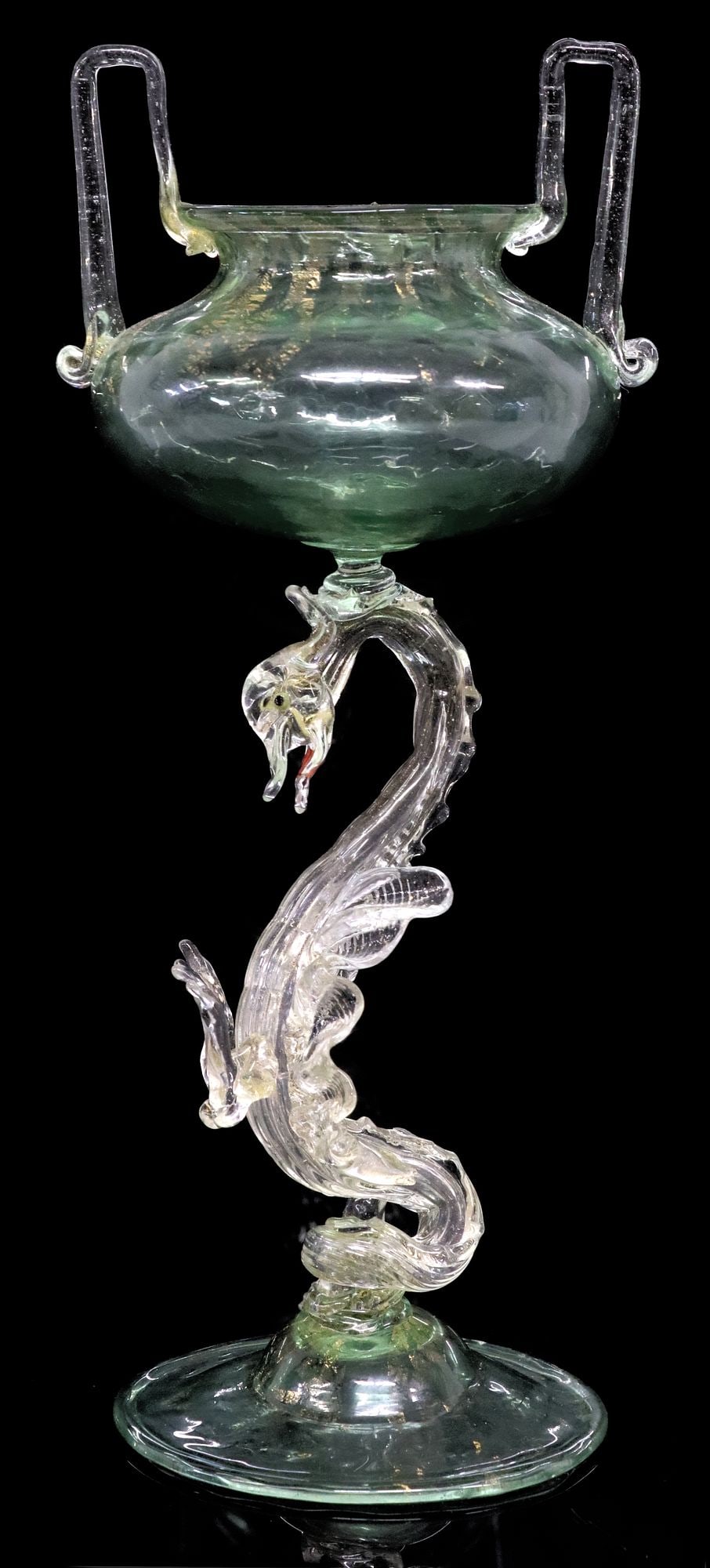 VENETIAN SALVIATI STYLE TRANSPARENT GREEN & GILT FLECKED GLASS VASE: Italian colorless and transparent green glass vase/ compote, in the manner of Salviati, fluted bowl with upright bracket handles, over the stem in the form of a stylized dragon, on a domed foot, appro