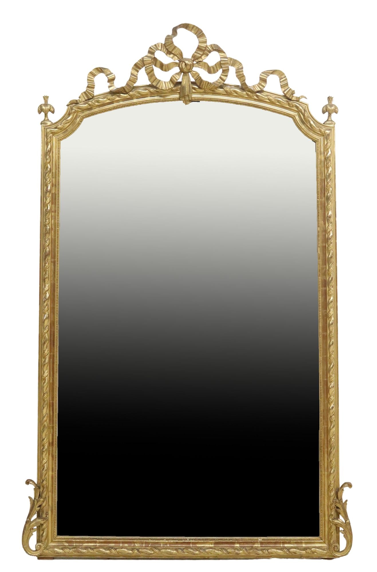 FRENCH LOUIS XVI STYLE GILTWOOD MIRROR, 71.5" X 40": French Louis XVI style giltwood mirror, late 19th c., having pierced ribbon crest, over shaped frame with molded trim, encasing later beveled mirror plate, approx 71.5"h, 40"w, 81lbs