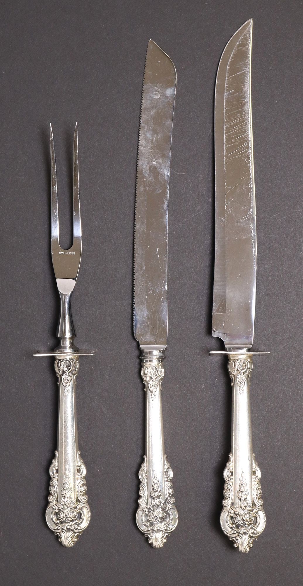 (3) WALLACE 'GRANDE BAROQUE' STERLING SILVER SERVICE FLATWARE: (lot of 3) American sterling silver serving flatware, Wallace Silversmiths, in the "Grande Baroque" pattern, each with stainless steel blade/ prongs, hollow sterling handle, no observed mono