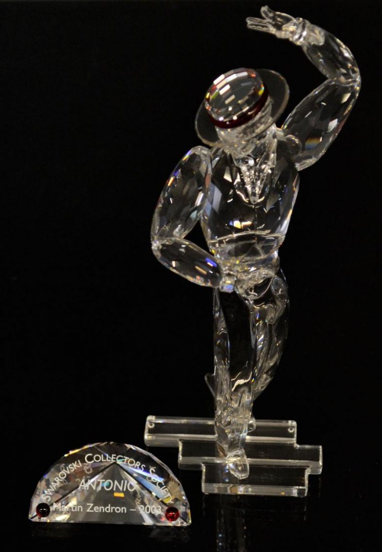 SWAROVSKI CRYSTAL MAGIC DANCE OF ANTONIO 2003: (lot of 3) Swarovski crystal figure 'Magic Dance of Antonio 2003', with certificate of authenticity, in original box, together with collectors display stand and Title plaque, figure: 8.5, largest box: