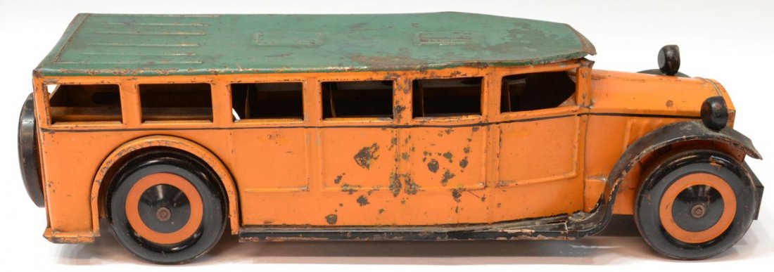 VINTAGE TOY TIN BUS: Vintage tin bus, a green top over yellow body, black and yellow disc wheels with spare mounted at rear, headlights on top of fender, not marked, rust, paint loss, 5.7/8"h, 21"l, 5.25"w, 2.75lbs Start 