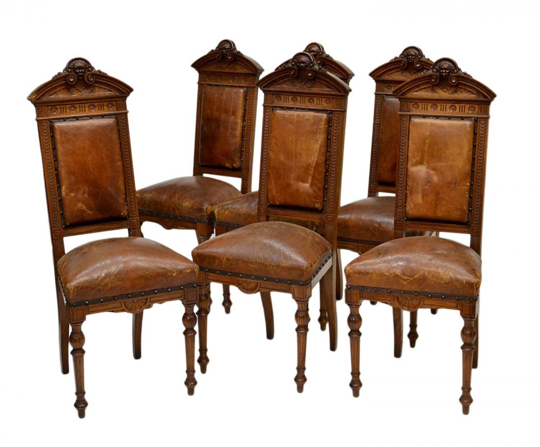 (6) ITALIAN ANTIQUE DINING CHAIRS: (lot of 6) Italian dining chairs, c. 1900, each with arched mask carved cornice at back rail, worn leather upholstery with some tears and abrasions, 42.5"h, 17"w, 17"d Start Price: $250.00
