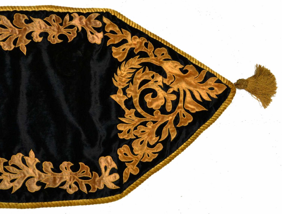 FARRISILK BLACK & GILDED TASSLED TABLE RUNNER: Farrisilk table runner, a black ground having gold scrolling foliate detail, roped trim, each end hung with a gold tassel, approx. 80"l (inclusive of tassels), 18"w, 1lb Start Price: $50.00