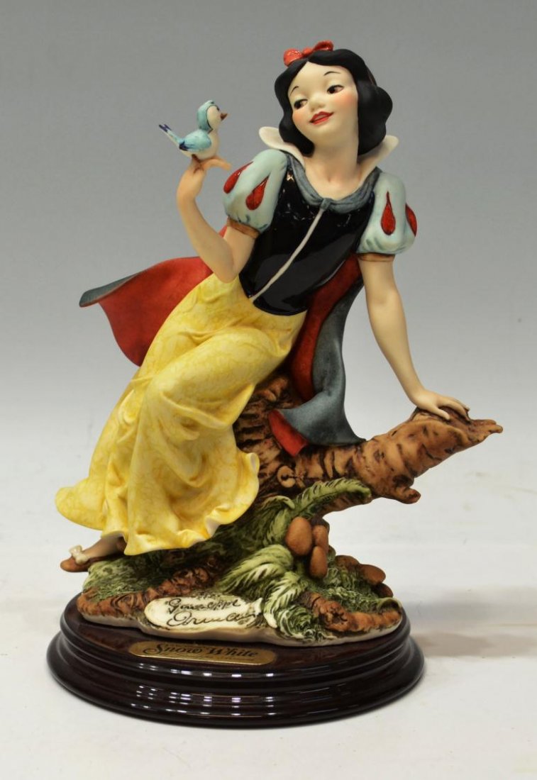 FIGURE, SNOW WHITE & BLUE BIRD, GIUSEPPE ARMANI: Figure, Snow White perched on a tree with a Blue Bird, signed Giuseppe Armani on foliage, engraved with copyright '1993 Florence' and 'Disney', 10.25"h, base: 6" diam, 3.25lbs Start Price: $200.00