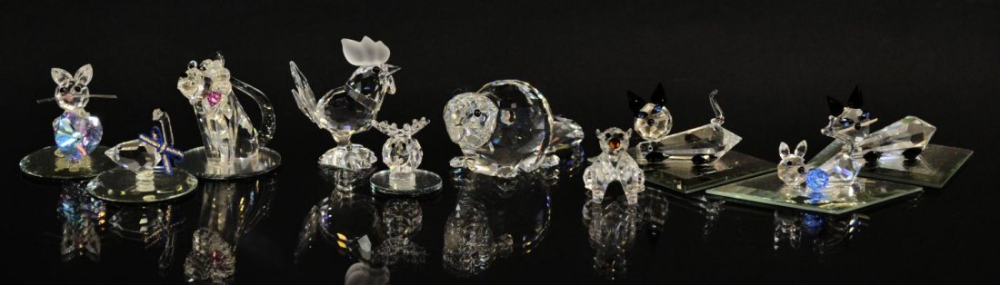 (10) CRYSTAL FIGURES & ANIMALS, POSSIBLY SWAROVSKI: (lot of 10) Collection of crystal animals, including, cats, a Swarovski beaver, a moose and lion, etc., some others possibly Swarovski, some having glue residue to base, largest: 1.5"h, 3.25"l, 0.75lb