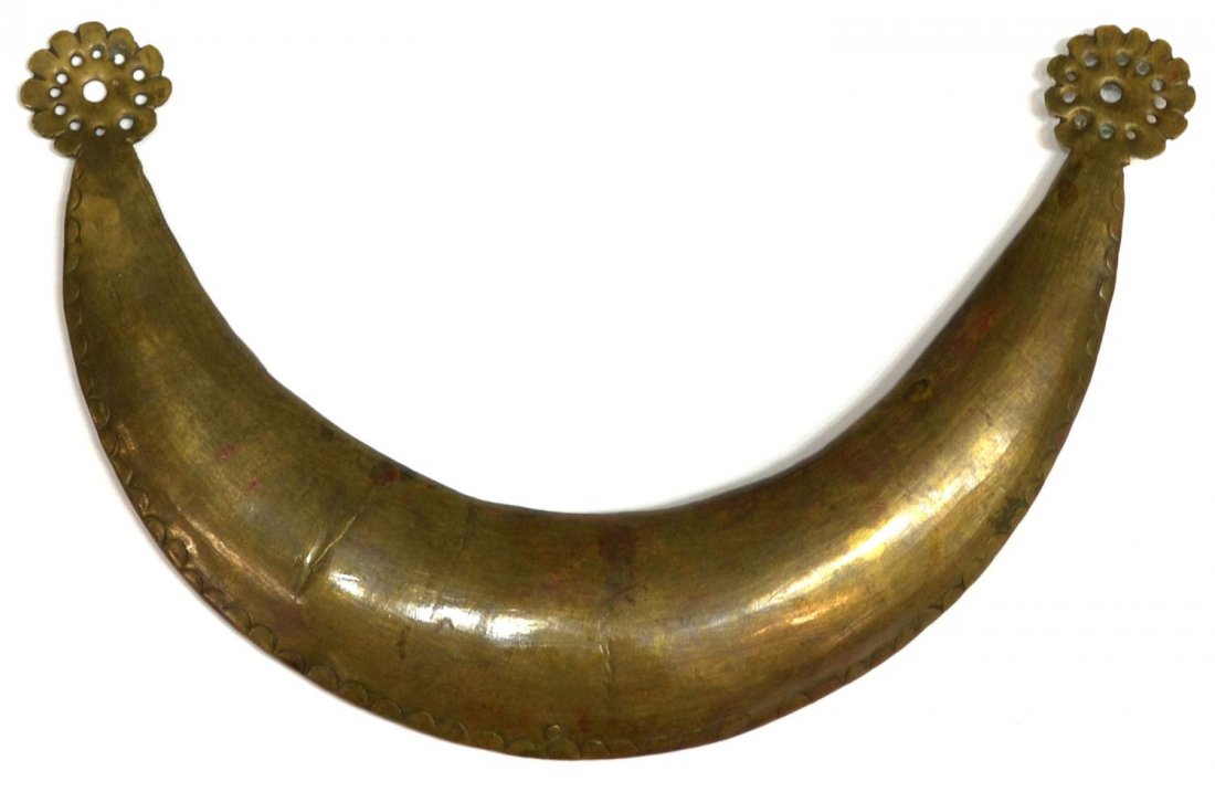 NATIVE AMERICAN BRASS CRESCENT MOON FORM GORGET: Native American gorget, pounded light brass in the form of a crescent moon terminating in pierced florets, possibly plains Indian, 3.75"h, 6"w, 0.25lbs Start Price: $50.00