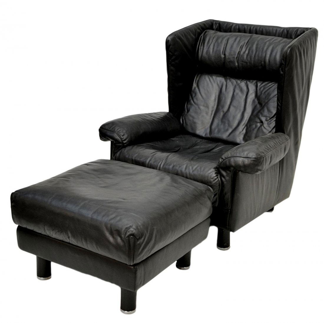 SWISS DE SEDE LEATHER ARM CHAIR & OTTOMAN: Swiss made de Sede leather wingback arm chair with matching foot stool, c. 1980, heavy black leather upholstery on each piece, circular black legs terminating in chrome caps, chair: 39.5"h, 35.5"w, 34