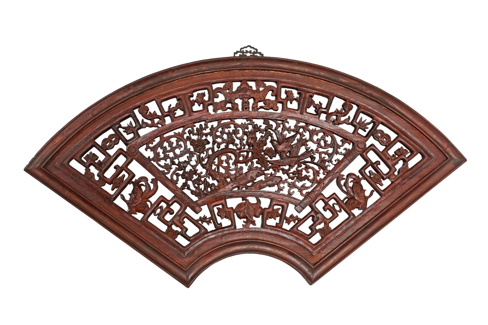 CHINESE CARVED HARDWOOD FAN-SHAPED PANEL: Chinese carved hardwood hanging panel, in the form of a fan, carved fretwork interspersed with foliates, and various traditional motifs such as lucky coins and ruyi scepter, centering pierced scene of