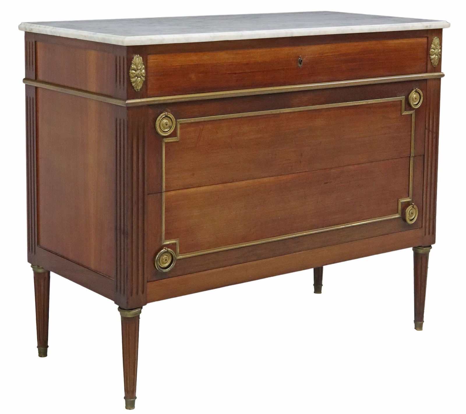 FRENCH LOUIS XVI STYLE MARBLE-TOP MAHOGANY COMMODE: French Louis XVI style mahogany commode, early 20th c., having marble top, over three drawers, with gilt metal trim, rising on fluted tapered legs, ending on brass cap feet, approx 34.25"h, 41&qu