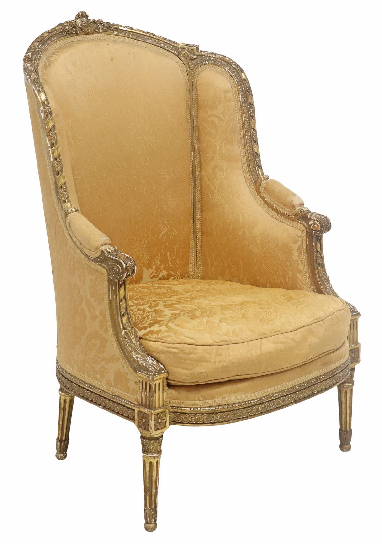 FRENCH LOUIS XVI STYLE GILTWOOD WING BERGERE: French Louis XVI style giltwood wing armchair, 19th c., worn damask upholstery, loose seat cushion, on tapering fluted legs modeled as quivers of arrows, approx 45"h, 29"w, 26.5"d, seat height: 18"h**