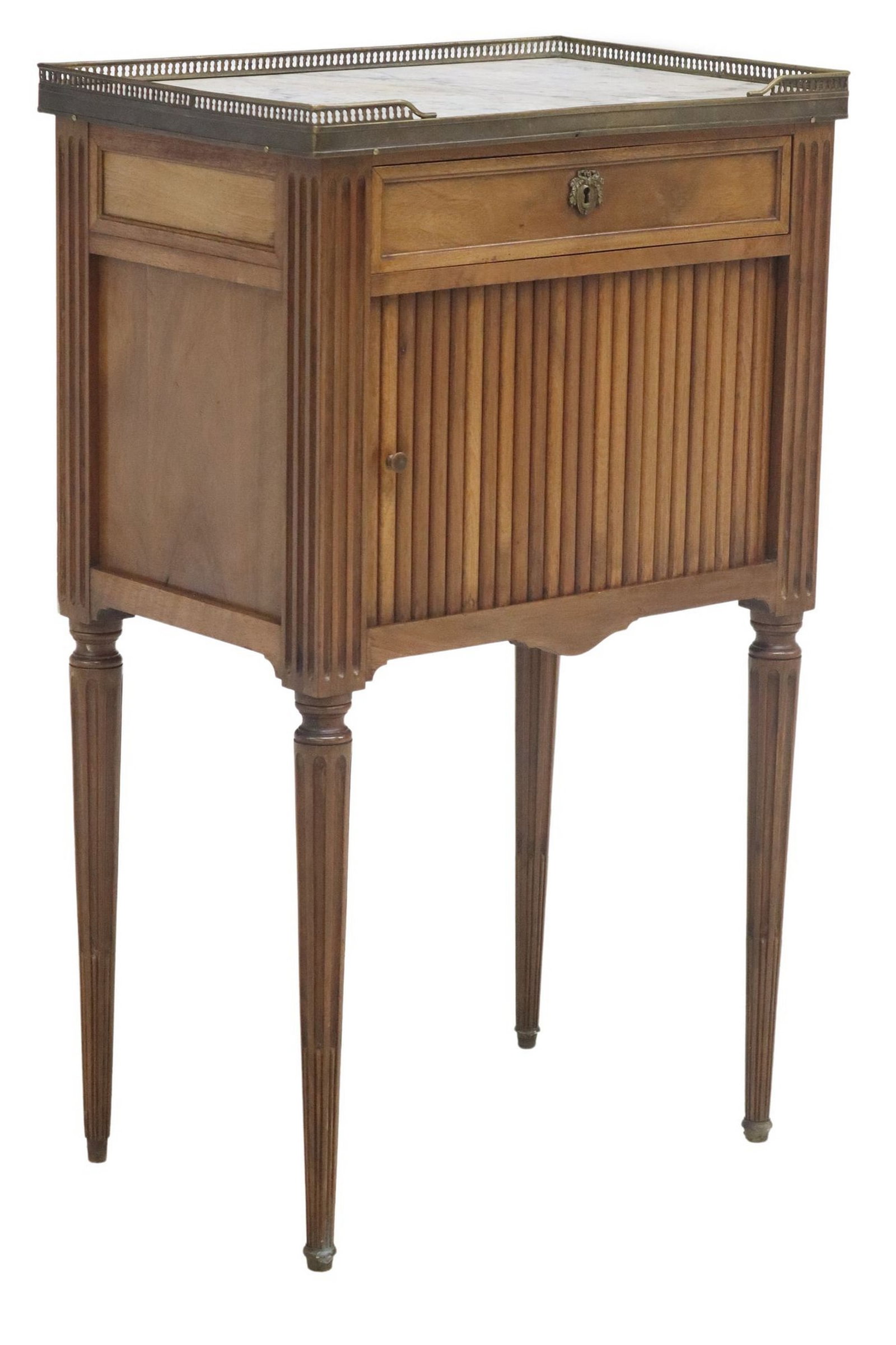 FRENCH LOUIS XVI STYLE MARBLE-INSET TAMBOUR NIGHTSTAND: French Louis XVI style walnut nightstand, 20th c., having inset marble top with gilt metal gallery, over sliding tambour door revealing open interior, rising on metal-capped fluted tapering legs, 
