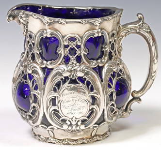 AMERICAN STERLING OVERLAY & BLOWN GLASS COUNTRY CLUB PRESENTATION PITCHER: American Art Nouveau silver-framed presentation pitcher, Whiting Manufacturing Company, New York, pattern number 3727, cobalt blue glass blown through a sterling silver frame chased and pierced w