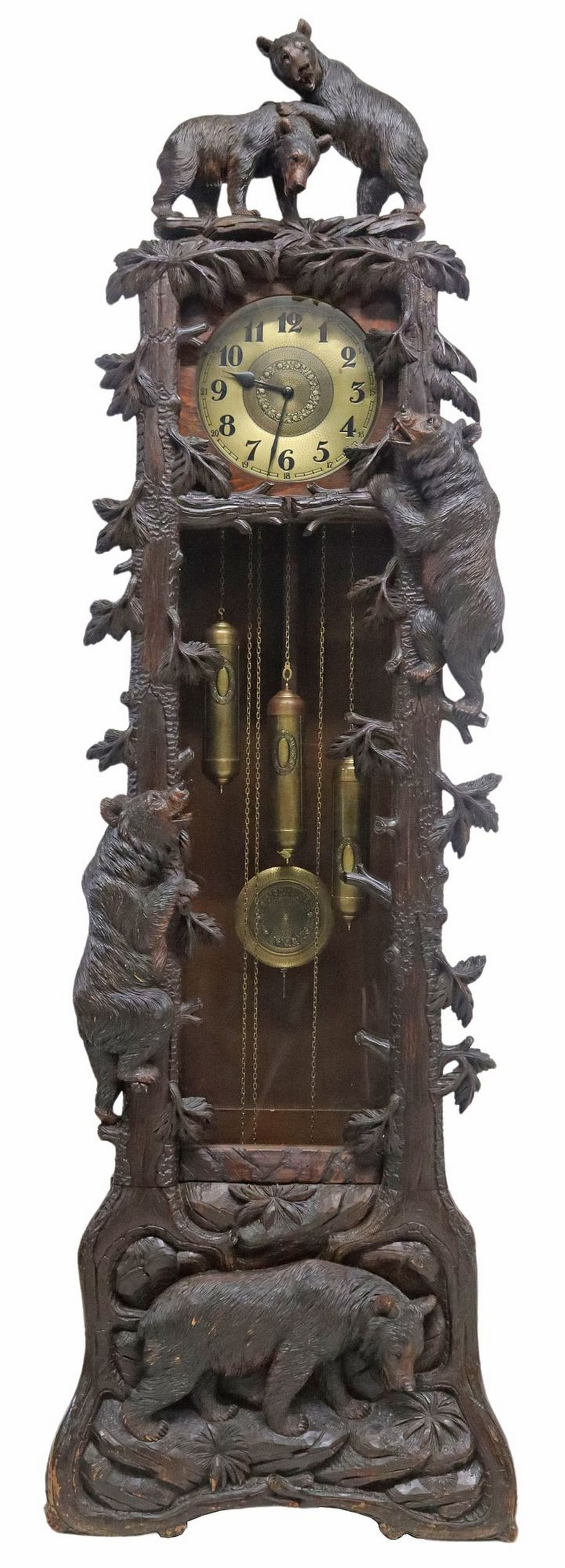 IMPRESSIVE SWISS BLACK FOREST CARVED MAHOGANY BEARS LONGCASE CLOCK: Swiss Black Forest finely carved mahogany longcase clock, late 19th c., topper depicting two bear cubs, above branch-form facade with naturalistic bark and foliates, three bears carved in high relief,