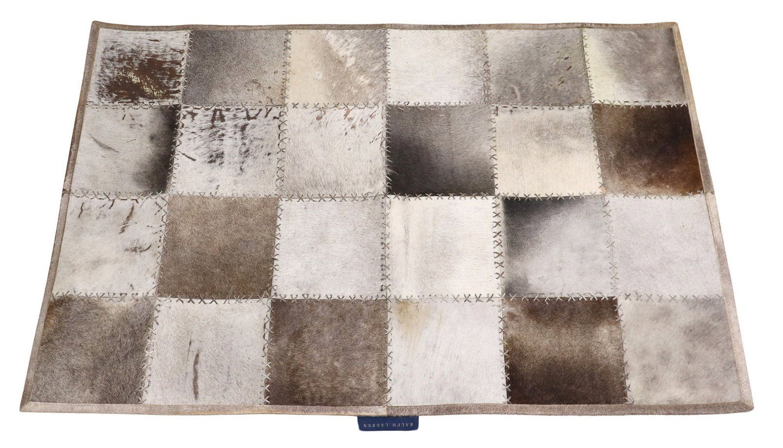RALPH LAUREN 'DOUGLAS' PATCHWORK COWHIDE RUG, 6' X 4': Ralph Lauren "Douglas" patchwork cowhide rug, square sections of alternating cowhide panels, with contrast stitchwork, maker's tag underfoot, some overall hair loss, approx 6'l, 4