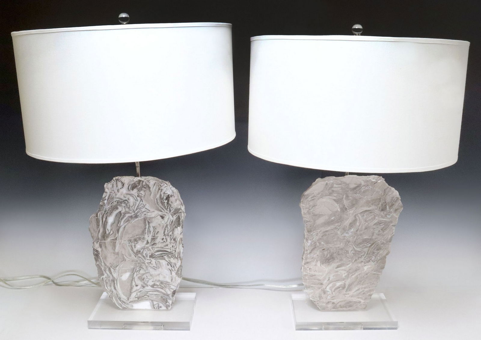 (2) CONTEMPORARY GEOLOGICAL STONE SLAB 1-LT TABLE LAMPS: (pair) Contemporary singe-light geological table lamps, each having chromed metal standard, behind stone slab with raw edge, rising on colorless acrylic base, accompanied by fabric drum shade, on