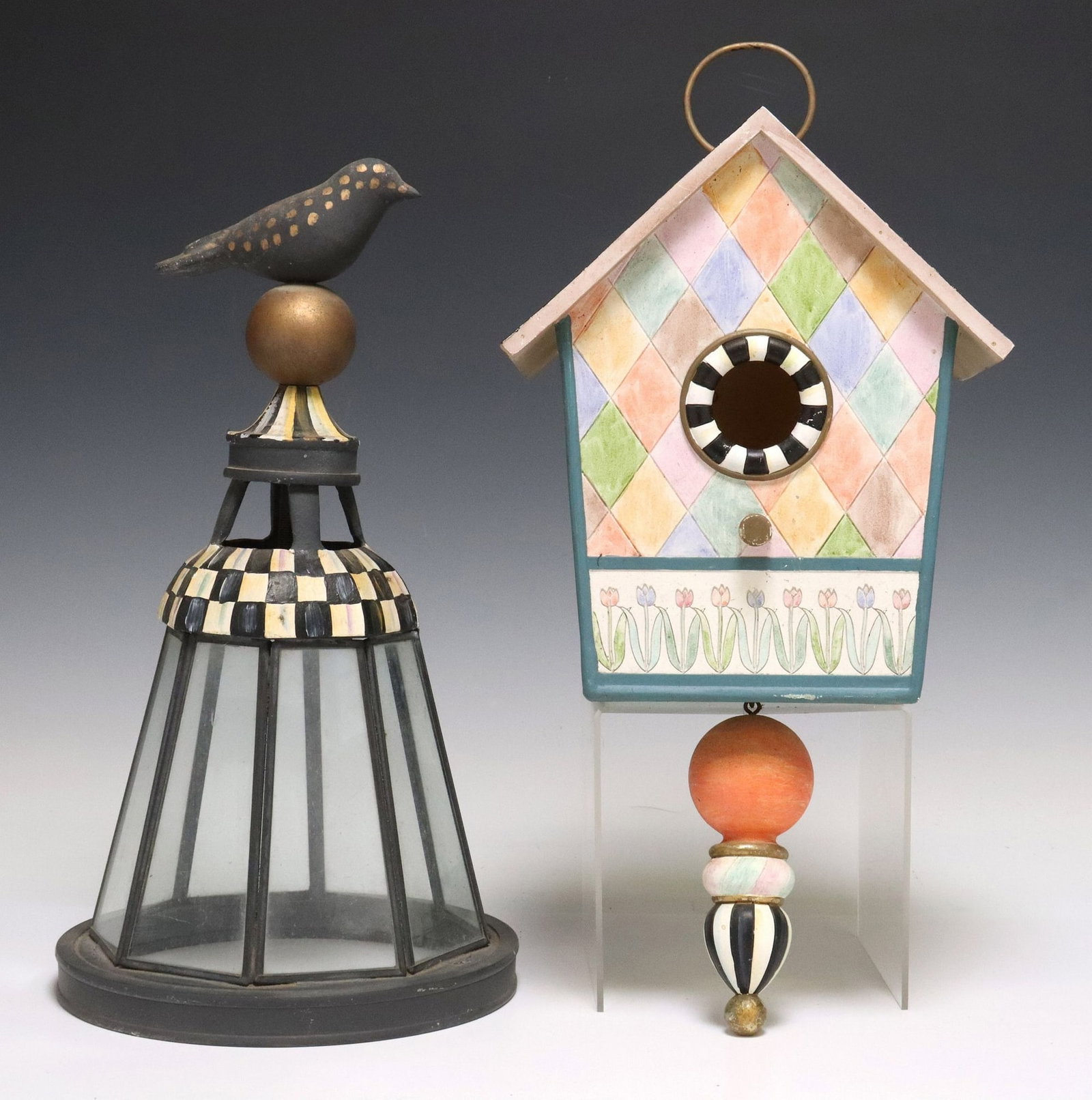 (2) MACKENZIE-CHILDS PAINTED GARDEN DECOR, BIRDHOUSE & LANTERN COVER: (lot of 2) Mackenzie-Childs hand-painted outdoor garden decor, 21st c., including: (1) wood birdhouse, with painted tulips, diamonds, and striped designs, tapered drop finial, maker's plaque at ba